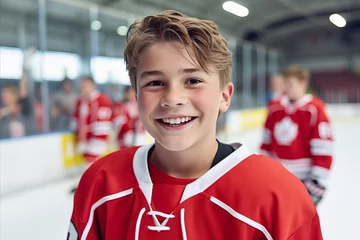 Fotobehang Smiling teenage hockey player on the ice of a hockey stadium © Александр Довянский