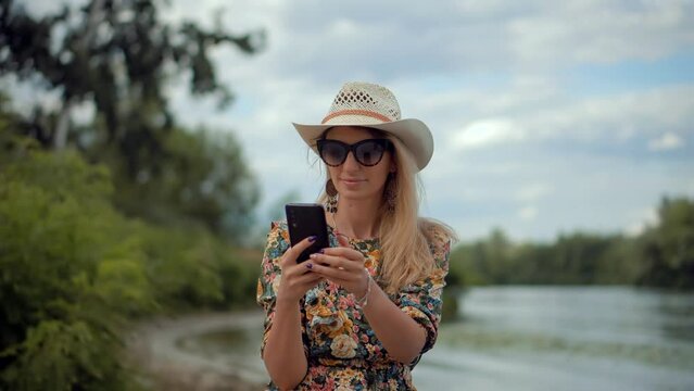 Woman in sunglasses using mobile phone and talking 