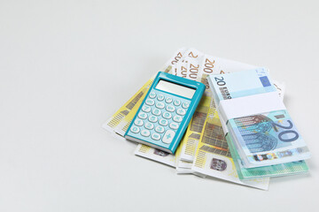 Stacks of American cash money and calculator on white background, space for text
