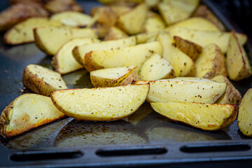 Potato wedges being baked in the oven