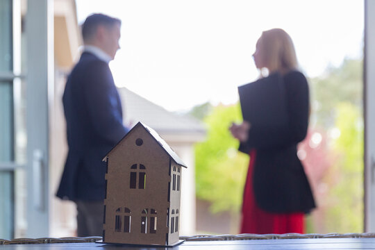 Real estate agent helps businessman to sell residence via agency on global estate market. Realtor and businessman discuss details