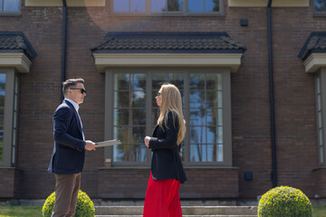 Blonde client asks about sale agreement with real estate agency. Businesswoman inspects new...
