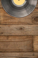 Vinyl record with blank label on a wooden table