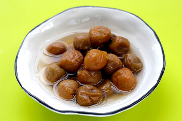 Pickled plums on white background.