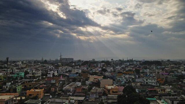 An aerial view of Dehradun, an Indian city during sunrise or sunset, with cloudy weather and rows of residential houses.
