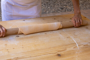 handmade tagliatelle with rolling pin, eggs, flour and water