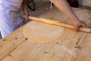 handmade tagliatelle with rolling pin, eggs, flour and water