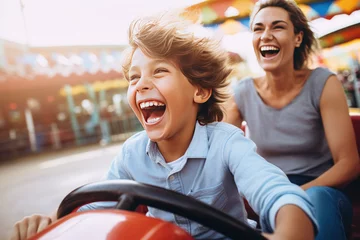 Deurstickers Joyful mother and son enjoying a fun summer, riding a bumper car at an amusement park © Kien