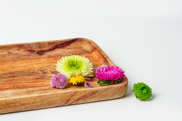 Wooden tray with flowers isolated on white background