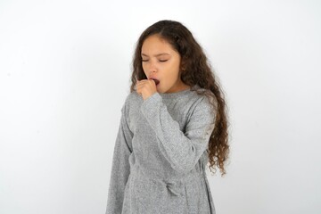 Beautiful teenager girl feeling unwell and coughing as symptom for cold or bronchitis. Healthcare...