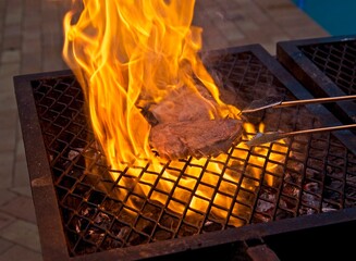 Flame grilled sirloin chops with flames