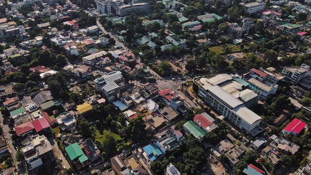 An aerial view of Dehradun, an Indian city during sunrise or sunset, with cloudy weather and rows of residential houses.
