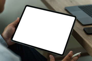 A businessman holds a mockup. iPad digital tablet with blank screen Mockup replaces your design...