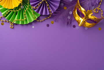 Festive Finery Arrangement: Top view capturing an extravagant New Orleans mask, colorful bead strand, feathers, confetti, and decorative paper fans on lively violet background with space for messaging - obrazy, fototapety, plakaty