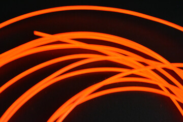 Unusual glowing background of chaotically stacked thin light wires, red glowing tourniquet,...
