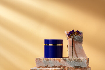 Cosmetic product jar in composition with granite stones and shadow