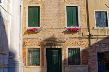 Fototapeta na wymiar Old town of Italian City of Venice witch facade of historic houses and flower decoration on a summer day. Photo taken August 6th, 2023, Venice, Italy.