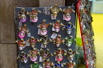 Close up of small colorful carnival masks outside of store at City of Venice on a cloudy summer day. Photo taken August 6th, 2023, Venice, Italy.