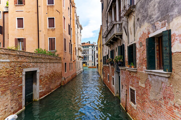 Scenic view of canal with historic buildings at City of Venice on a cloudy summer day. Photo taken August 6th, 2023, Venice, Italy.