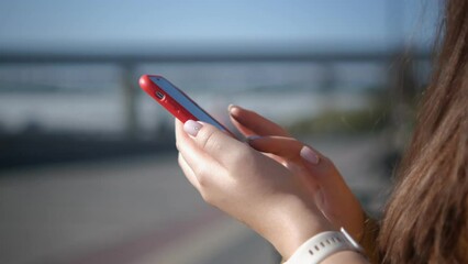 Finger of woman touching scroll page app on mobile phone. Browsing movie video in the internet library to watch film online. 4K