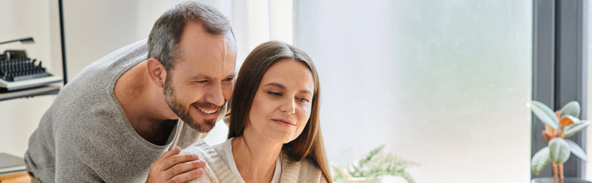 cheerful man embracing shoulders of smiling wife at home, child-free lifestyle, horizontal banner