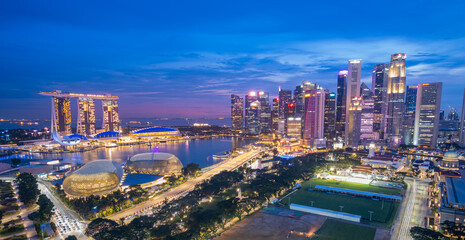 Singapore, Singapore - October 23, 2023: Singapore cityscape at dusk. Landscape of Singapore business building around Marina bay. Modern high building in business district area at twilight. - obrazy, fototapety, plakaty