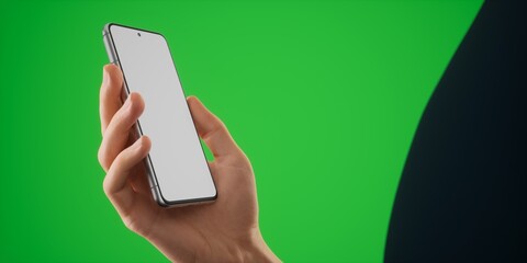 Caucasian man holding phone on a green background, blank screen mockup