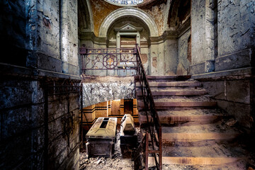 The abandoned mausoleum with open coffins