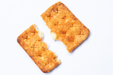 Broken stem ginger biscuits with crumbs isolated on white. Top view.