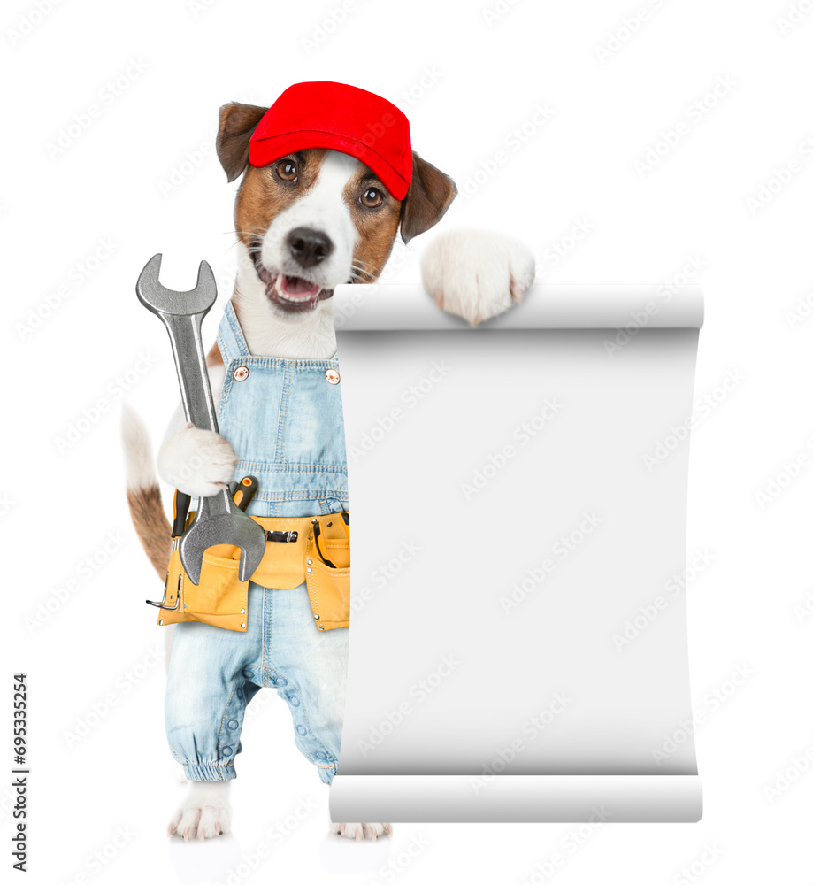 Aufkleber Funny puppy wearing red cap and denim overalls with tool belt shows empty list and wrench. Isolated on white background