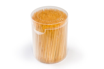 Wooden bamboo toothpicks in plastic container on a white background