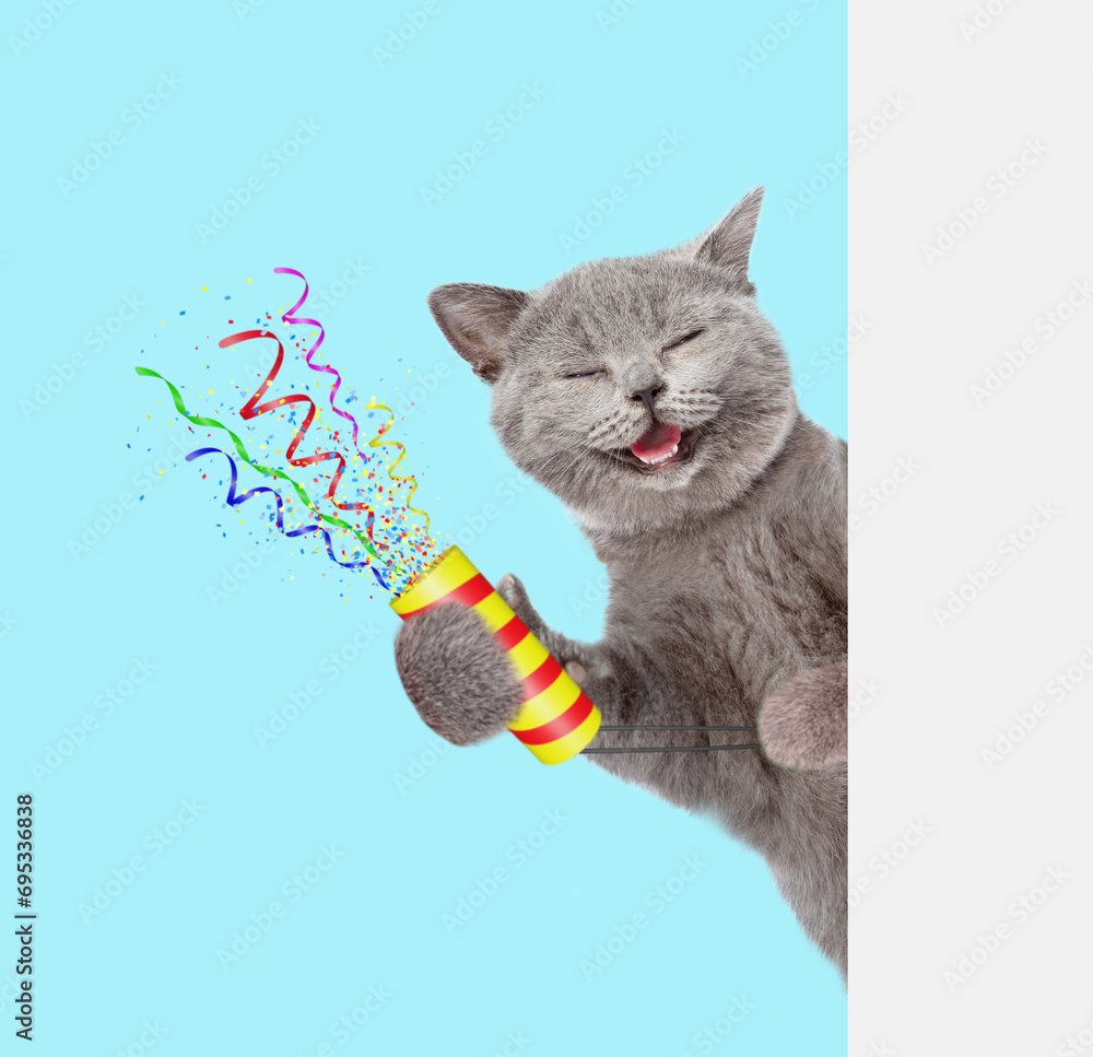 Aufkleber Happy cat holds exploding firecracker and looks from behind empty white banner. Isolated on blue background