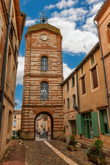 Medieval village of Auvillar and its clock tower, in Tarn et Garonne, Occitanie, France - 695338002