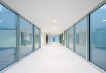 Hospital with empty white passage and glass walls