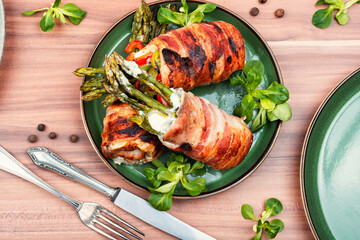Meat rolls stuffed young green asparagus.