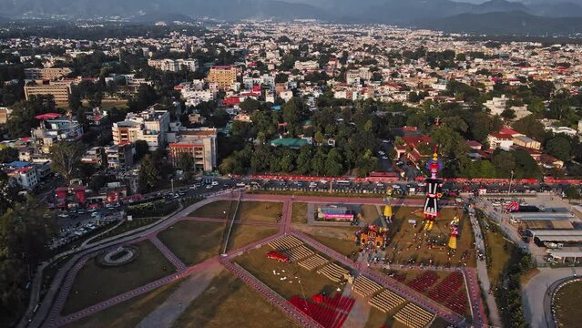 Aerial shot of the Ravan statue during the Dussehra or Vijayadashami Festival in Pared Ground, Dehradun, with traffic passing by alongside.