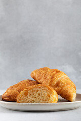 Fresh croissants on a grey background. French breakfast. Copy space