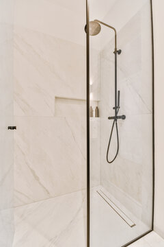 Modern shower cabin with tiled walls and showerhead