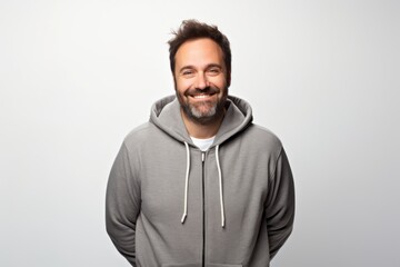 Fototapeta premium Portrait of a blissful man in his 40s wearing a zip-up fleece hoodie against a white background. AI Generation