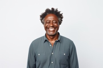 Portrait of a cheerful afro-american man in his 50s wearing a simple cotton shirt against a white background. AI Generation