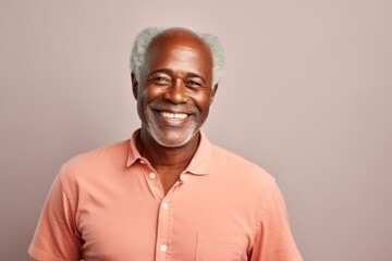 Fototapeta premium Portrait of a cheerful afro-american man in his 50s wearing a simple cotton shirt against a white background. AI Generation