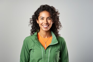 Portrait of a smiling indian woman in her 20s sporting a technical climbing shirt against a white background. AI Generation - obrazy, fototapety, plakaty