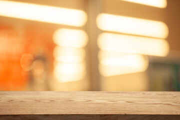 brown wooden board on blurred cafe bokeh background