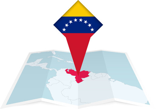 Venezuela pin flag and map on a folded map