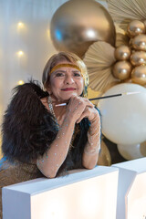 Senior woman in 1920s attire with a cigarette holder at a themed birthday event.