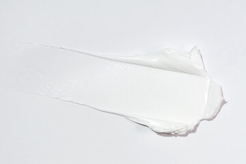 white cosmetic face cream or body lotion moisturizer stroke on white background. Hygiene, skincare...