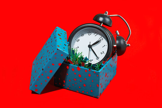 Conceptual image of alarm clock inside gift box