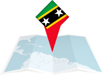 Saint Kitts and Nevis pin flag and map on a folded map