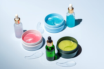Assortment of colorful skincare cosmetics on a light background