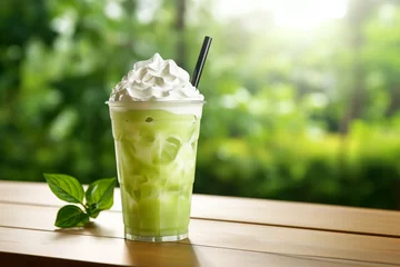Foto op Canvas Iced green tea fresh milk with whipped cream on wooden table and blur background © Robin